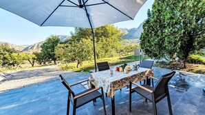 An outdoor dining area with a table set for four, surrounded by chairs, under a large umbrella. - Beautiful private villa for 6 people with private pool, A/C, WIFI, TV, terrace and pets allowed (Monreale)
