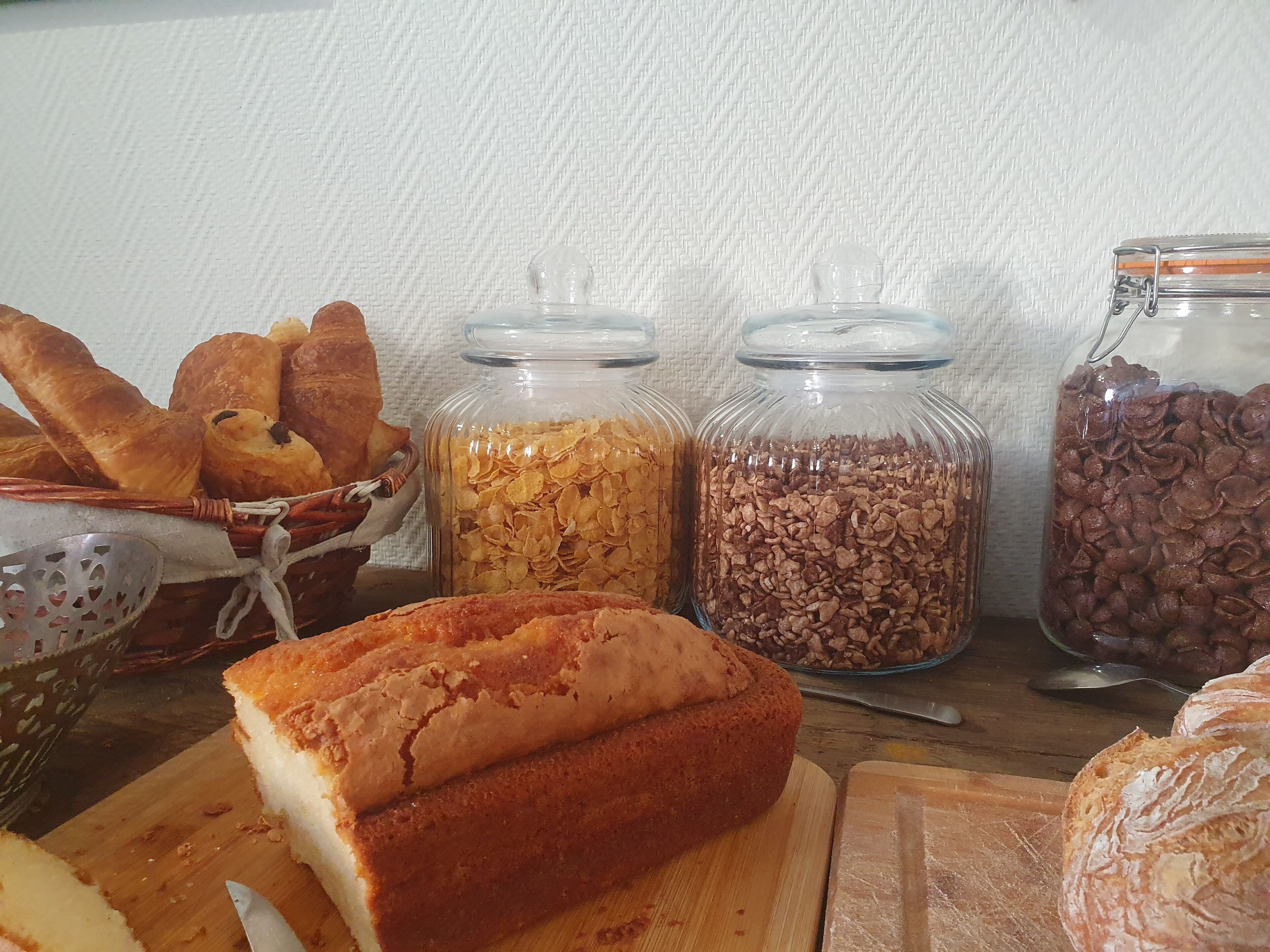 A variety of baked goods and grains on a wooden table.