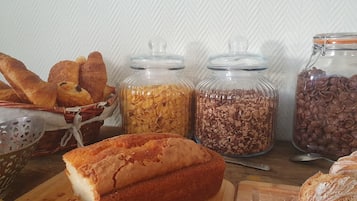 A variety of baked goods and grains on a wooden table.