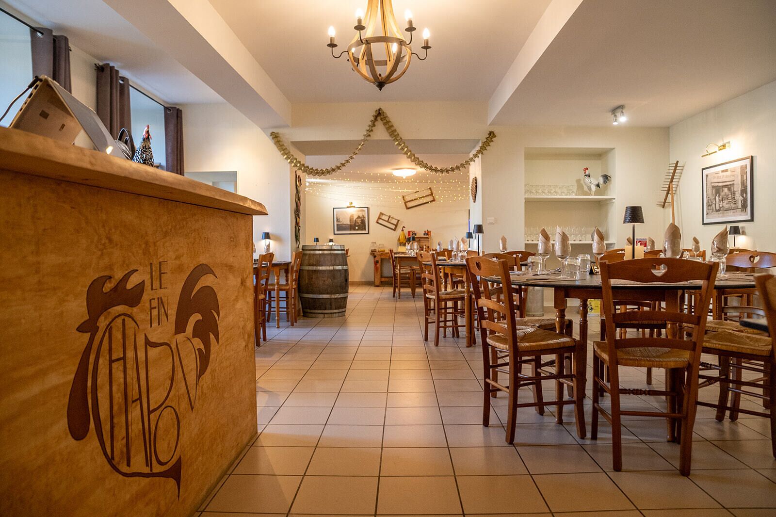 A restaurant with wooden furniture, a bar area, and festive decorations.