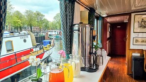 A bar area with a view of boats and a cityscape.