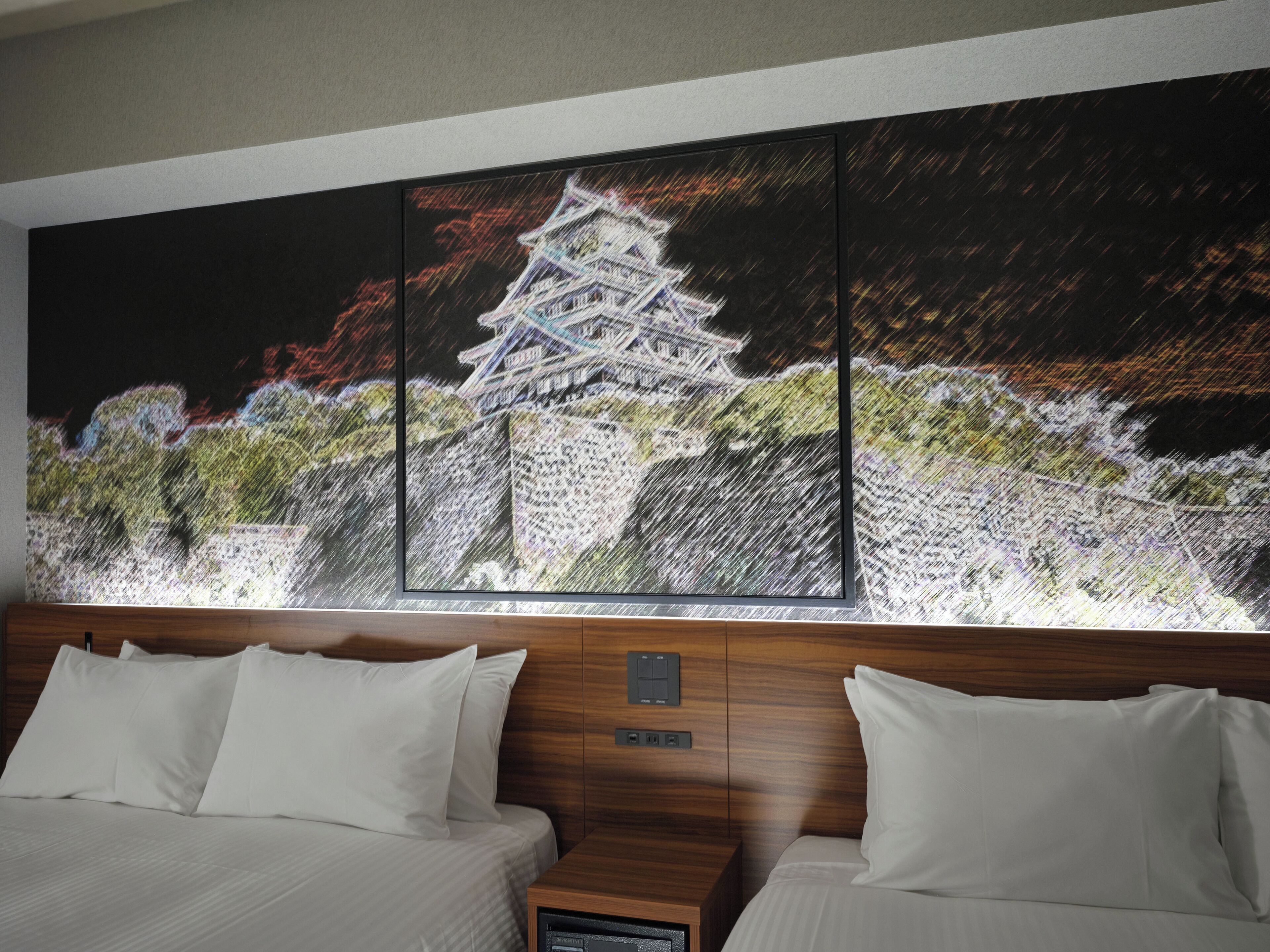 A hotel room with a large painting of a traditional Japanese pagoda on the wall, a wooden headboard, and a bed with white bedding.
