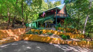 A cabin with a porch, surrounded by trees and a landscaped area with steps leading up to it. - New Listing! Mtn Cabin: Fire pit, Hot tub Views (Cherry Log)