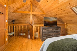 A wooden cabin interior with a bed, dresser, and a television on a stand. - 4 BR Cabin near Banner Elk/Beech Mtn. Hot Tub, Fire Pit & Yard (Banner Elk)