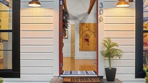 A wooden door with a number '306' and a sign reading 'Kirted Cowboy Ideas.' - Kilted Cowboy - Cowboy Pool, Hot Tub & Fire Pit (Fredericksburg)