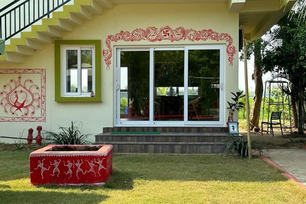 A building with a staircase, a large glass door, and a red decorative border.