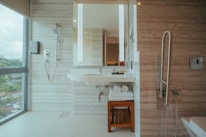 A modern bathroom with a large window, a shower, a sink, and a wooden stool. - Kandy Myst by Cinnamon (Kandy)