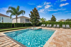 A rectangular swimming pool with a hot tub in the center, surrounded by a brick patio. - Arcades, Bocce, Haunted Mansion Theater, Cabana, Enchanted Forest: Great Escape (Kissimmee)