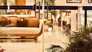 A hotel lobby with a sofa, potted plants, and a reception desk. - Hotel Bayberry Kathmandu - Near Tribhuvan International Airport (Kathmandu)