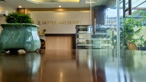 A reception desk with a sign reading "HOTEL BAYBERRY" and a potted plant in the foreground. - Hotel Bayberry Kathmandu - Near Tribhuvan International Airport (Kathmandu)