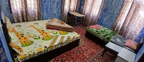 A room with a bed, a small table, and a sofa.