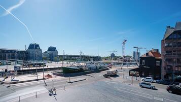 A harbor with a green boat docked, a tram line, and a building with a sign that reads "Waterside."