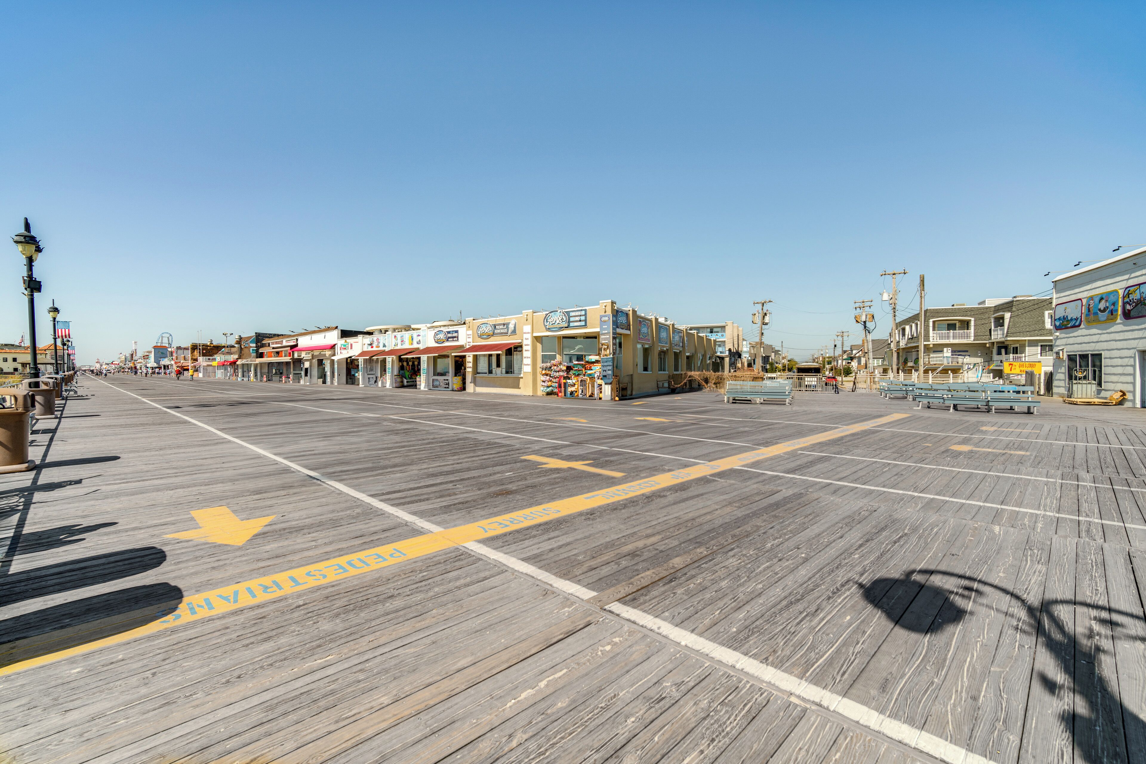 A boardwalk with shops and benches.