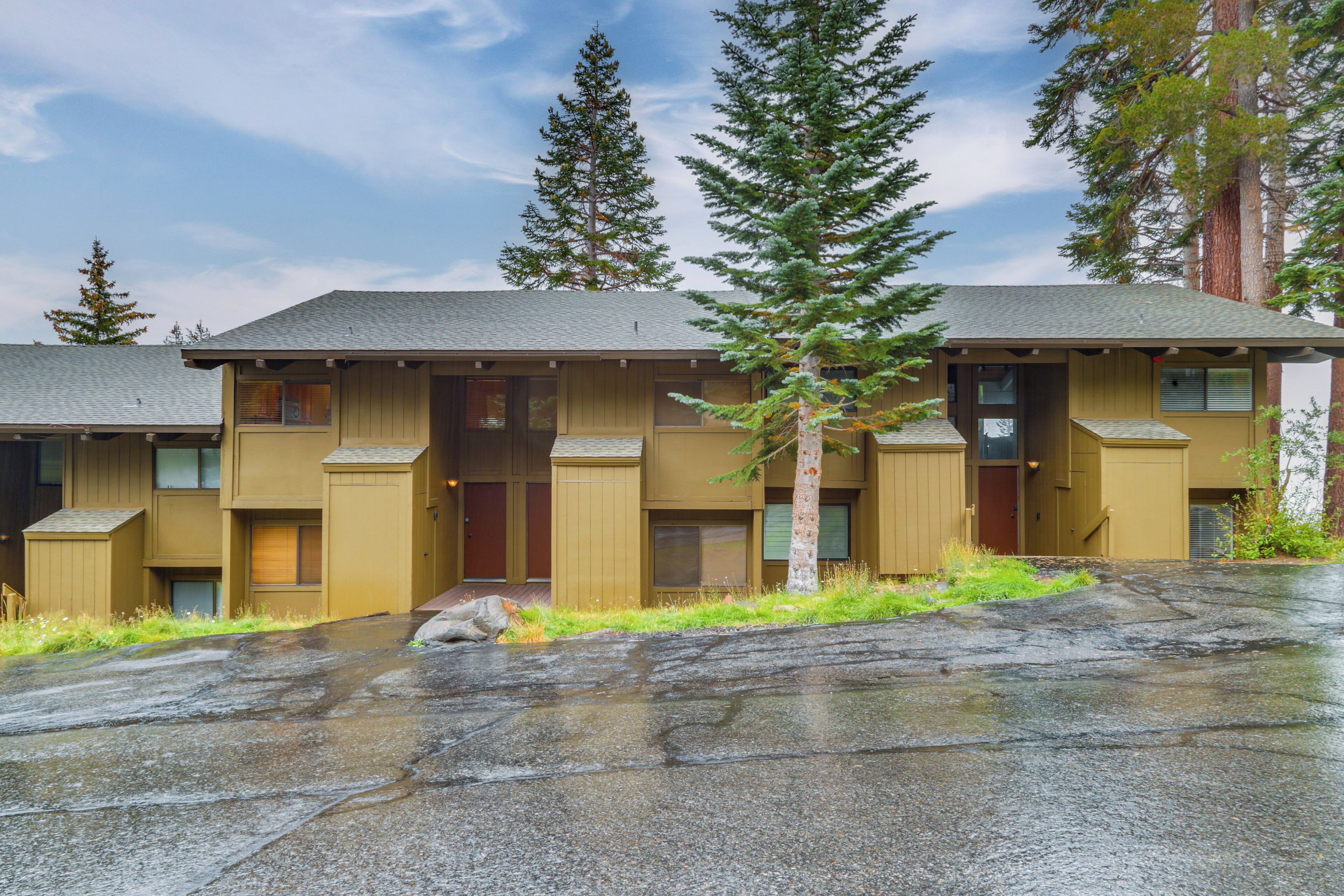 A two-story motel with a central entrance and individual rooms on either side.