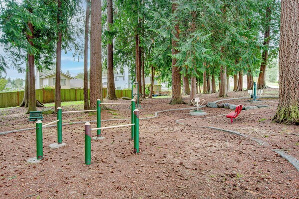 A playground with climbing structures and a red bench.