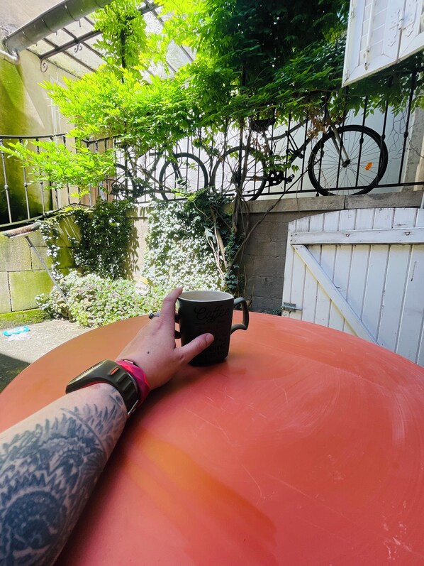 Guests can enjoy a quiet moment with a cup of coffee in this serene outdoor space.
