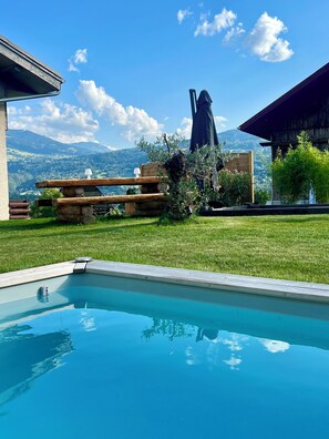 A swimming pool with a clear view of mountains in the background.