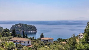 A coastal property with a view of the sea and a small island. - Skopelos Seaview Suite - Athena Summer Nest (Stafylos)