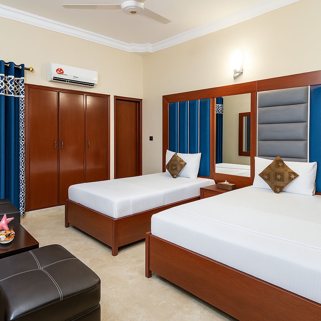 Ein Hotelzimmer mit zwei Betten, einem Kleiderschrank, einer Klimaanlage, einem Schreibtisch mit Stuhl und einem Deckenventilator.