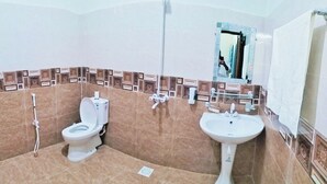 A bathroom with a toilet, bidet, and sink. - Hotel Subhan Palace 2 (Karachi)