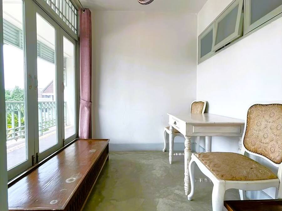 Una habitación con un banco, una mesa y sillas.