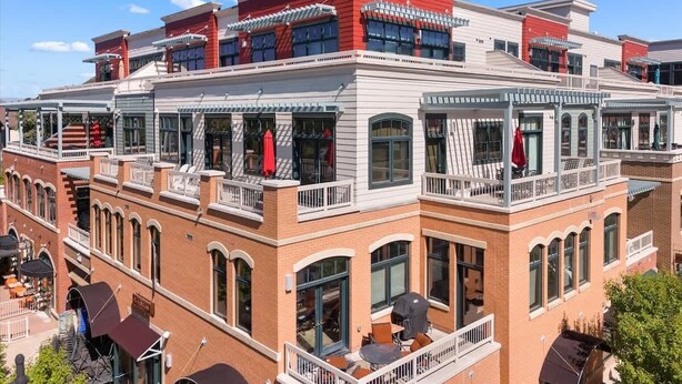 A multi-story hotel with balconies, large windows, and a brick facade.