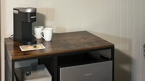 A compact coffee machine on a wooden table with two white cups and a placemat. - Pet Friendly & Private 3BR Raised Home, Blocks to the Beach! (North Myrtle Beach)