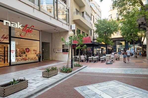 A shopping area with a store named 'nak light' and a restaurant with outdoor seating.
