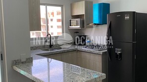 Fridge, microwave, coffee/tea maker, cookware/dishes/utensils