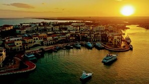 A coastal town with a marina, boats, and buildings.