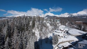 A snow-covered mountain landscape with buildings and trees.