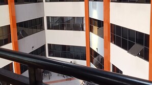 A multi-level atrium with a central open space, surrounded by balconies and staircases. - Dutse Suites and Luxury (Abuja)