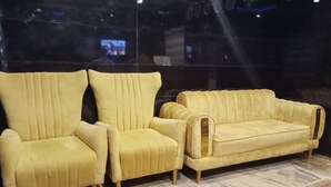 A yellow sofa set with a marble-patterned floor. - Dutse Suites and Luxury (Abuja)