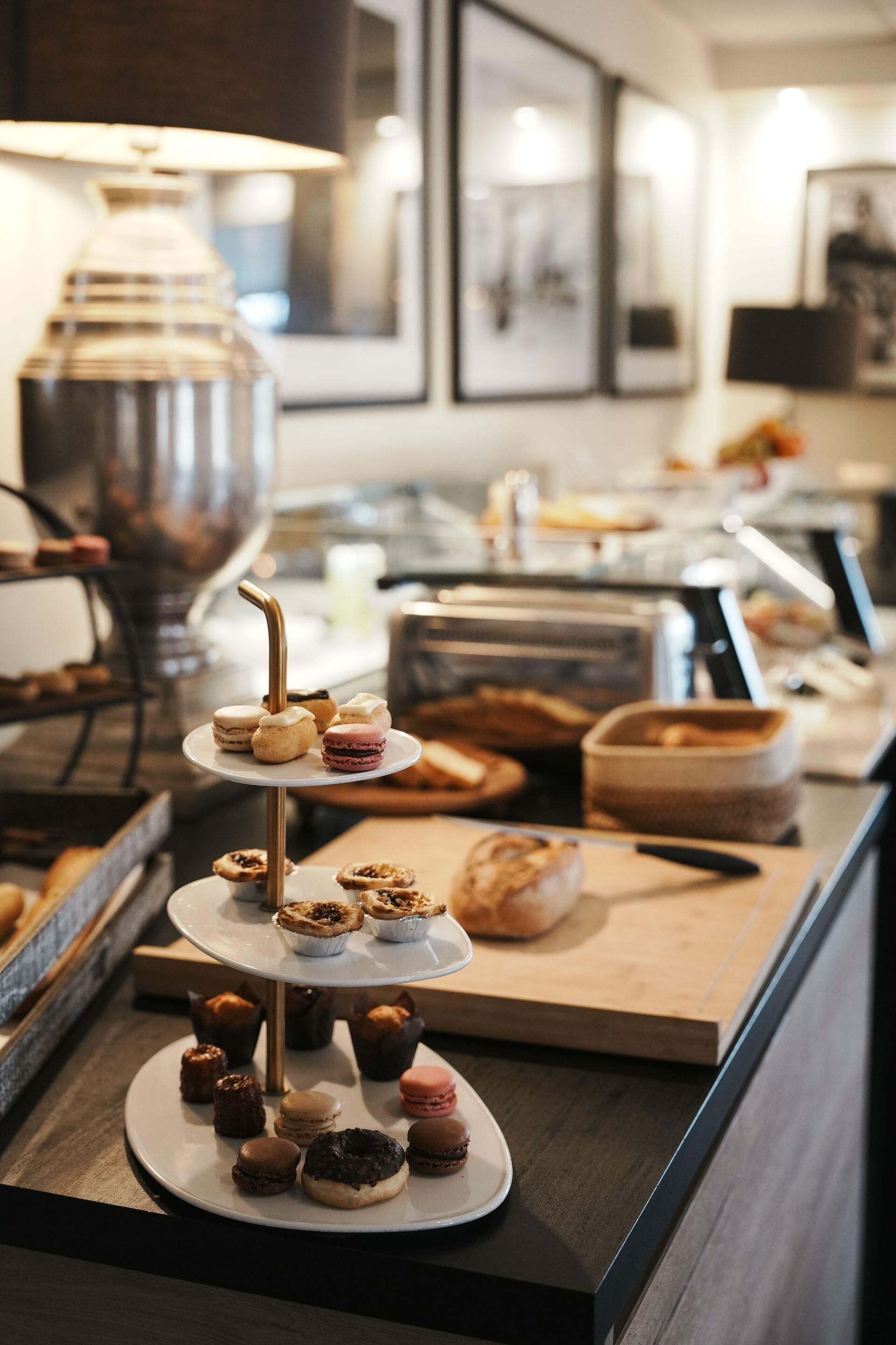 A buffet with various pastries and desserts on tiered stands.