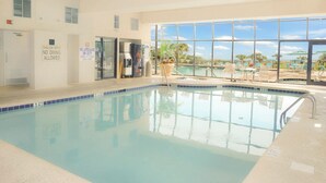 An indoor swimming pool with a 3 FT depth marking, a lifeguard station, and a view of the outside pool area. - New Listing! Meridian Plaza Resort #606 (Myrtle Beach)