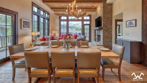A spacious dining area with a wooden ceiling and large windows offering a mountain view. - The BEST Ski In/Out! Immediately next to Montage! (Big Sky)