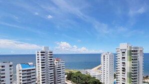 A high-rise building with multiple floors, a view of the ocean, and a clear sky. - PARCEROS GROUP - 2 BEDROOM VACATION APARTMENT, 14TH FLOOR, CARTAGENA, SPAIN (Cartagena de Indias)