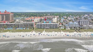A coastal town with a beach, hotels, and a large building with a red roof. - Bermuda Run 103A-2BR-Pool, Hot Tub (North Myrtle Beach)