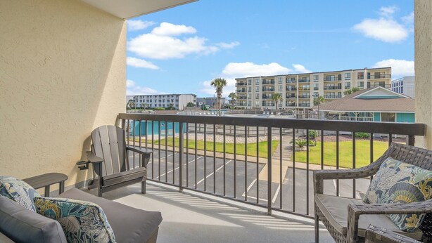 A balcony with a view of a parking lot and buildings. - Bermuda Run 103A-2BR-Pool, Hot Tub (North Myrtle Beach)