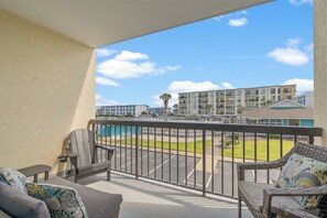A balcony with a view of a parking lot and buildings. - Bermuda Run 103A-2BR-Pool, Hot Tub (North Myrtle Beach)