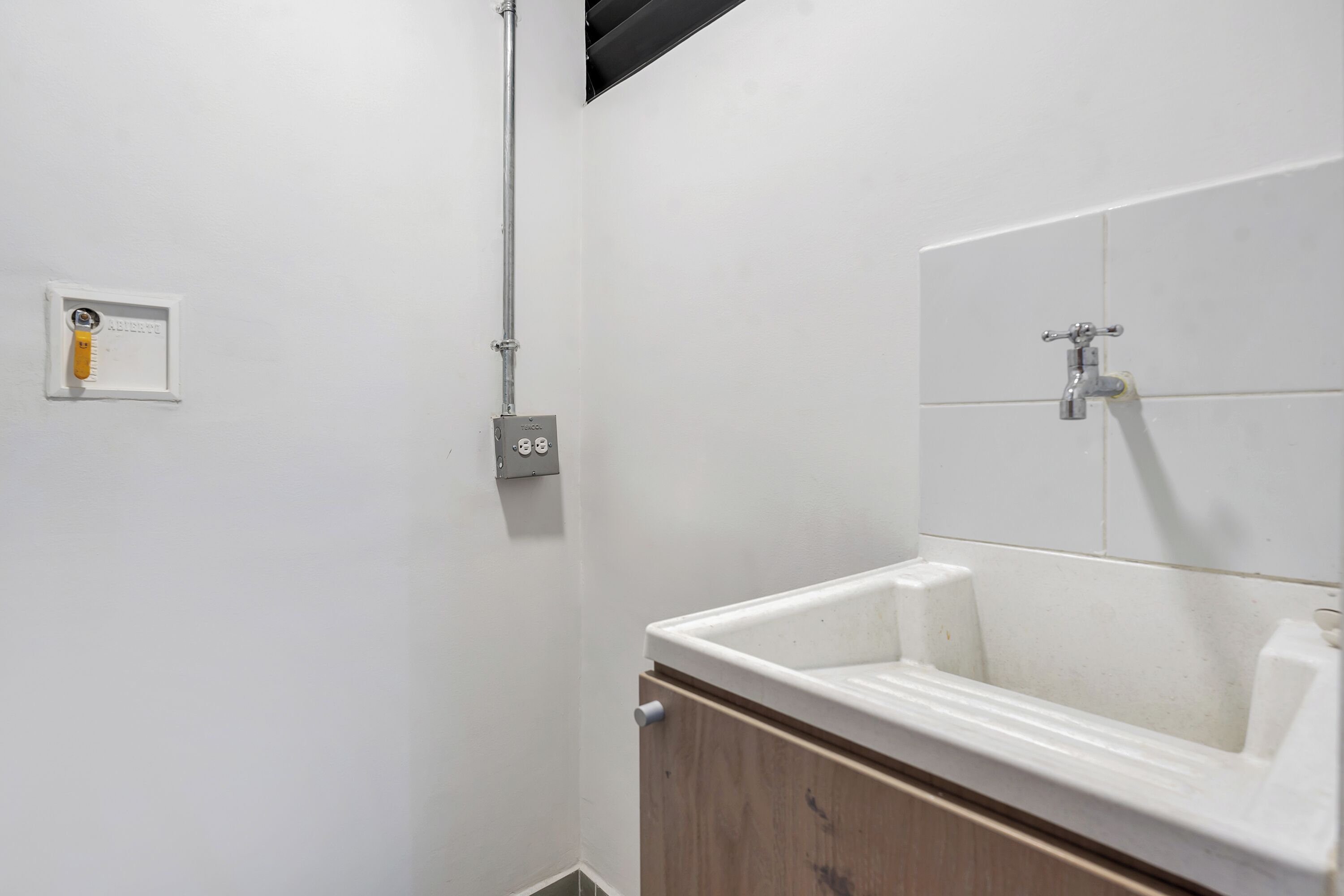 A bathroom with a white sink, a mirror, and a shower.
