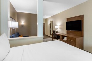 Relax in comfort with a large bed, desk, and flat-screen TV in this inviting space.