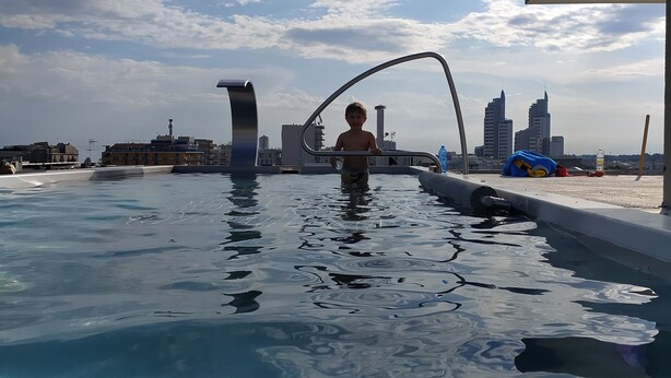 A pool with a city skyline in the background.