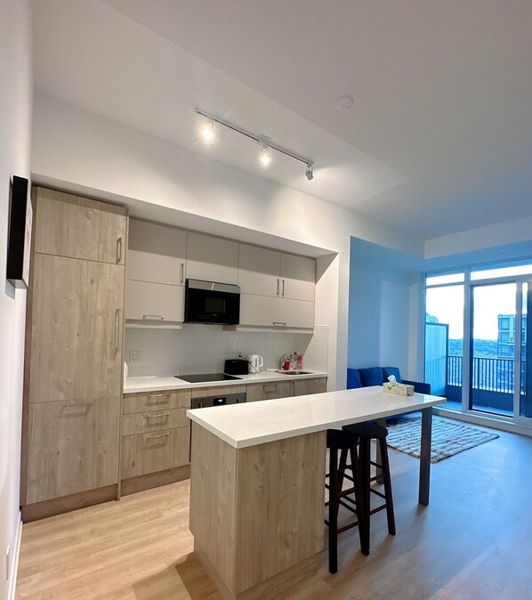 Enjoy meals in the kitchen with a central island and bar stools, equipped with a microwave and coffee maker.