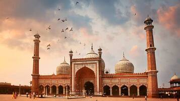 A large mosque with two minarets and a central dome, surrounded by a spacious courtyard.