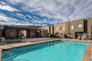 A swimming pool with a pergola, outdoor chairs, and a view of mountains. - Entrada at Moab 624 (Moab)