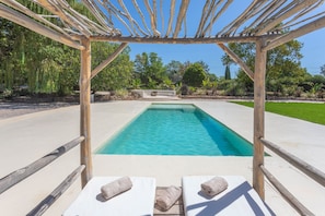 A pool with a wooden pergola, lounge chairs, and a view of the surrounding greenery. - Holiday Home 'Domaine Montserrat' with Mountain View, Private Pool and Wi-Fi (Le Luc)