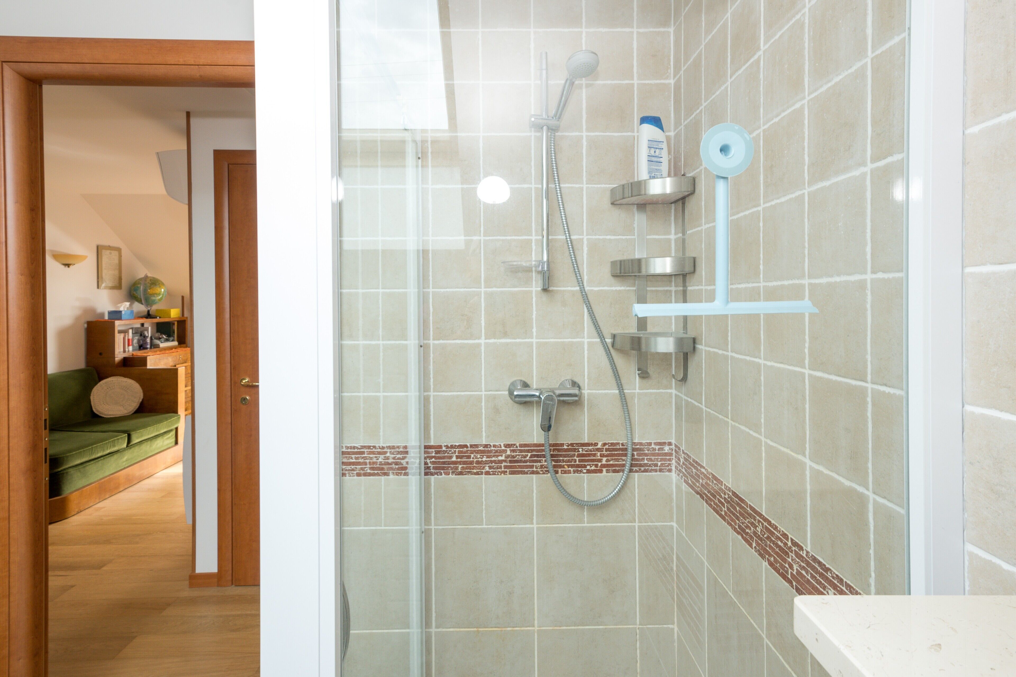 A bathroom with a shower, a toilet, and a sink.