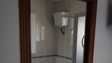 Ein Badezimmer mit Toilette, Bidet und Duschkabine.