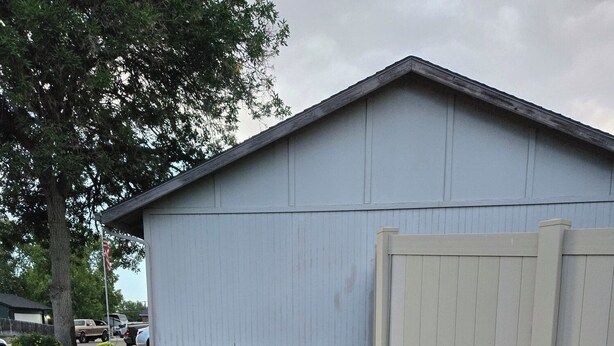 A building with a paved driveway leading to a gated entrance. - Charming studio in fabulous Meridian, Idaho with WiFi, AC, Private entry. (Meridian)